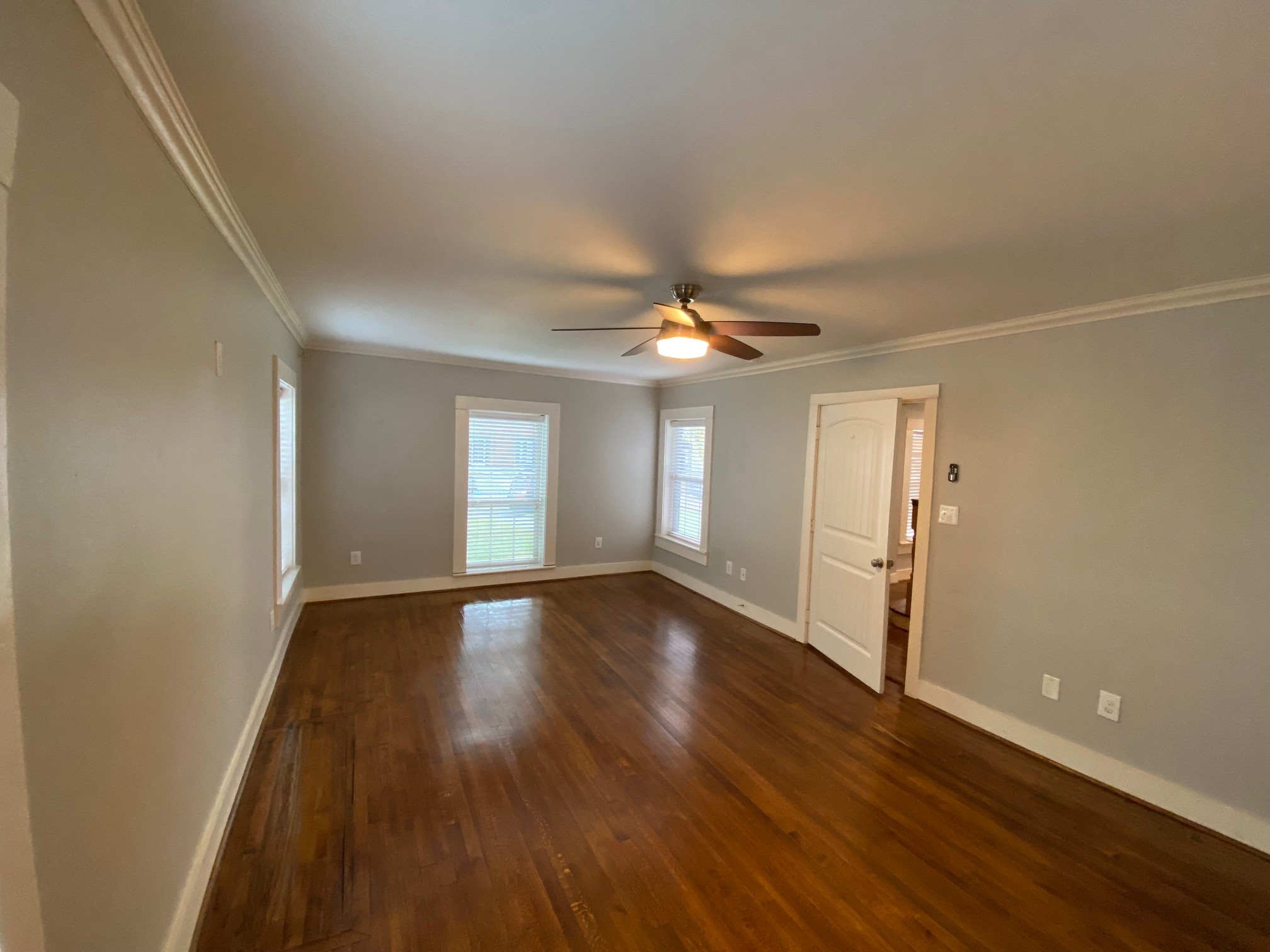 3209 Milburn Street Houston, TX 77021 - Photo 15 of 45 a view of an empty room with wooden floor and a window