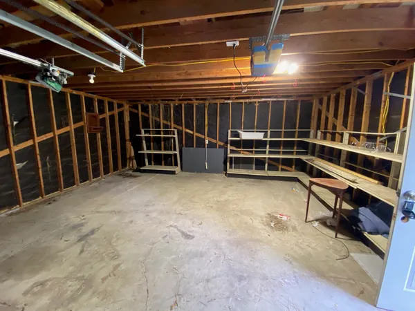 a view of an empty room with wooden shelves