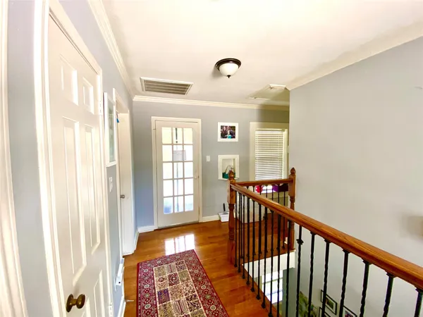 a view of a hallway with windows and stairs