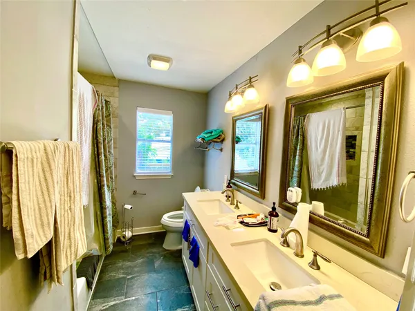 a bathroom with a sink mirror and a bathtub