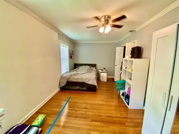 a bedroom with a bed and a ceiling fan