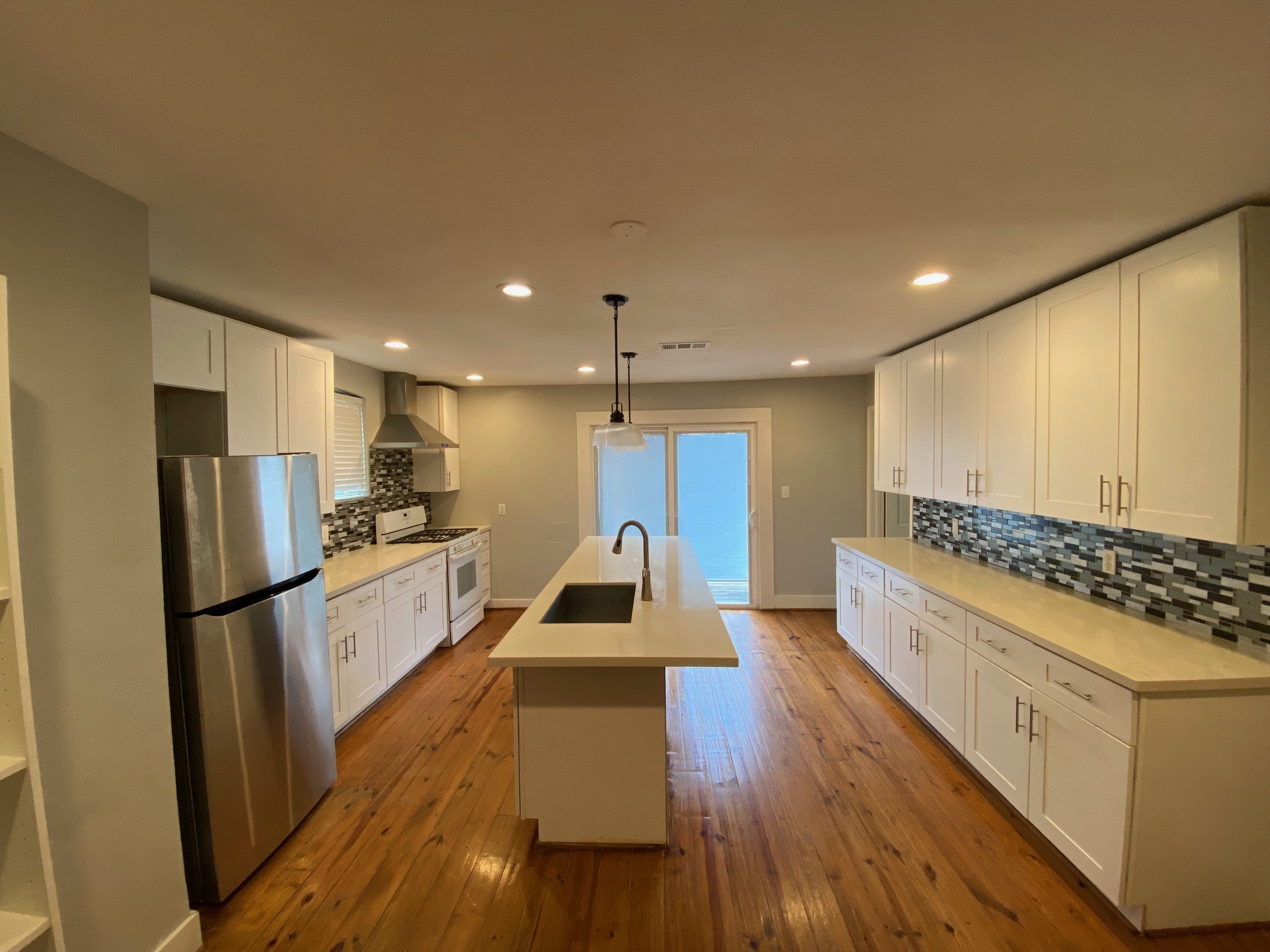 3209 Milburn Street Houston, TX 77021 - Photo 10 of 45 a kitchen with stainless steel appliances granite countertop a refrigerator a stove and a wooden floors