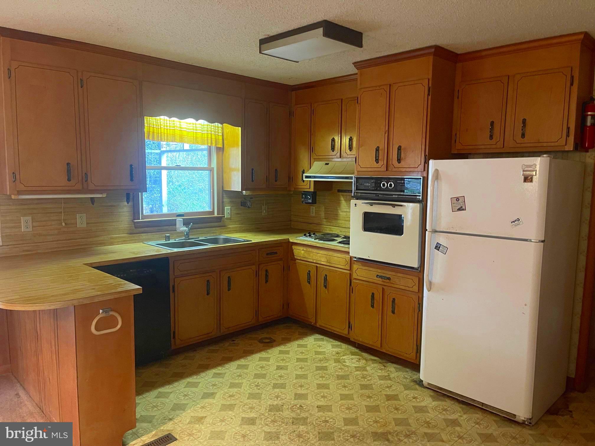 37339 Main Street Ocean View, DE 19970 - Photo 4 of 13 a kitchen with sink cabinets and window
