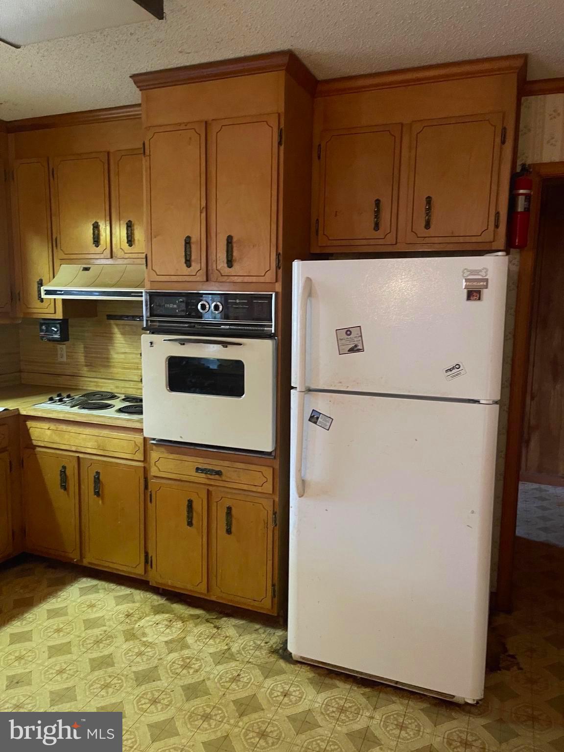 37339 Main Street Ocean View, DE 19970 - Photo 5 of 13 a kitchen with granite countertop cabinets stainless steel appliances and a sink