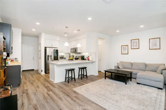 a living room with furniture and kitchen view
