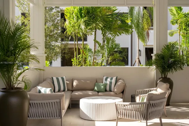 a view of a couches and a table and chairs in patio