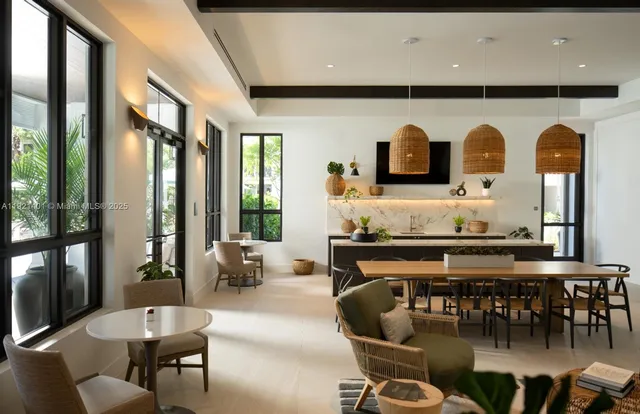 a living room with furniture a flat screen tv and floor to ceiling windows