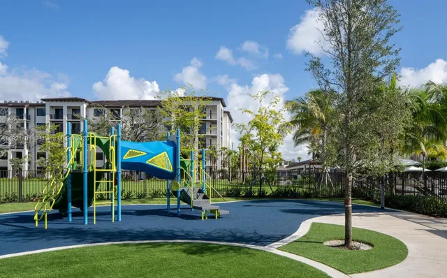 a swimming pool with lots of tress in front of it