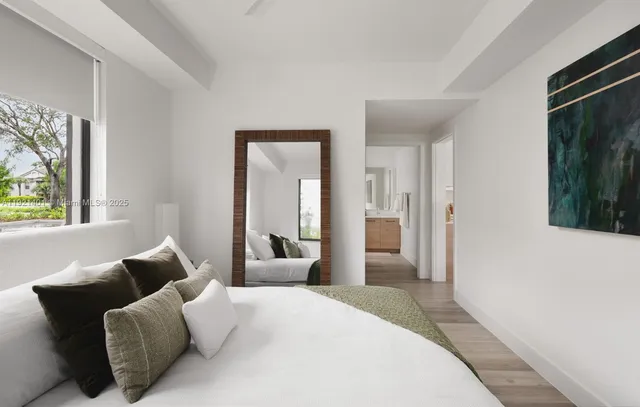 a bedroom with furniture and a window