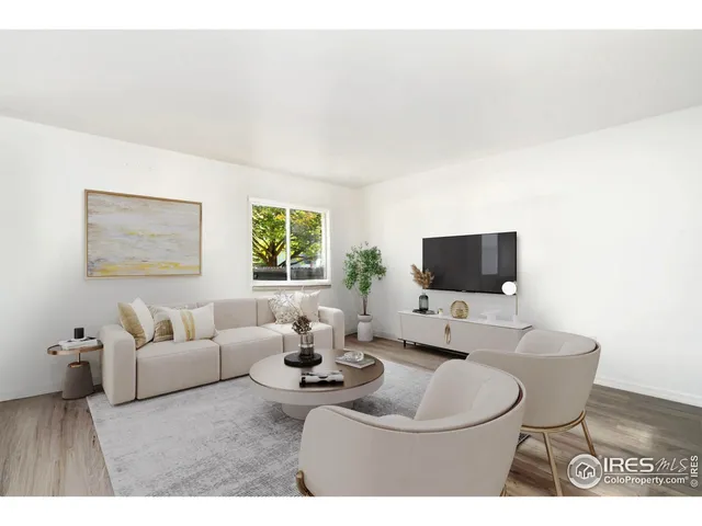a living room with furniture a flat screen tv and a large window