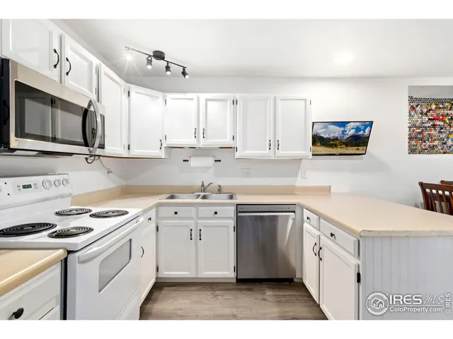 a kitchen with stainless steel appliances granite countertop a stove a sink dishwasher and a refrigerator