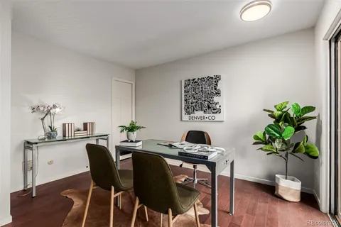 a dining room with furniture and wooden floor