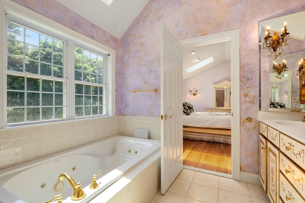 15 Beaver Brook Road Canton, MA 02021 - Photo 19 of 33 a bathroom with a tub sink and mirror