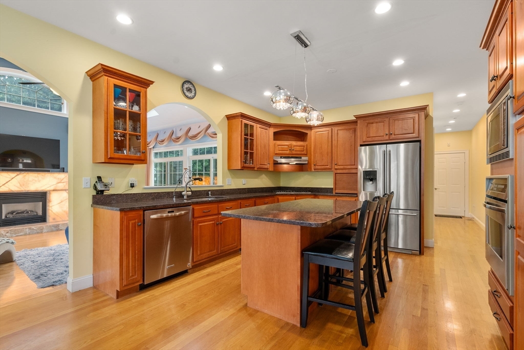 15 Beaver Brook Road Canton, MA 02021 - Photo 6 of 33 a kitchen with stainless steel appliances granite countertop table chairs sink and cabinets