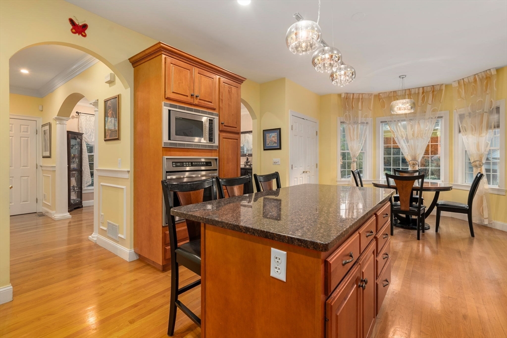 15 Beaver Brook Road Canton, MA 02021 - Photo 8 of 33 a kitchen with a table chairs refrigerator and cabinets