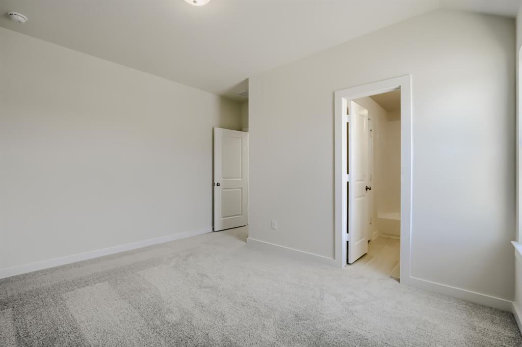 828 Stone Grv Road Lavon, TX 75166 - Photo 18 of 27 Neutral carpet flooring and light-toned walls