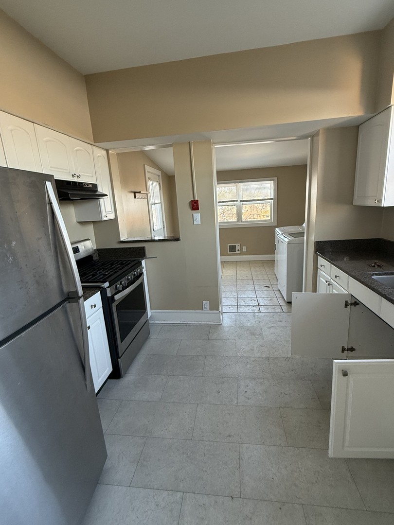 314 West Main Street, Unit 3R St. Charles, IL 60174 - Photo 7 of 11 a kitchen with stainless steel appliances a stove a sink and a refrigerator