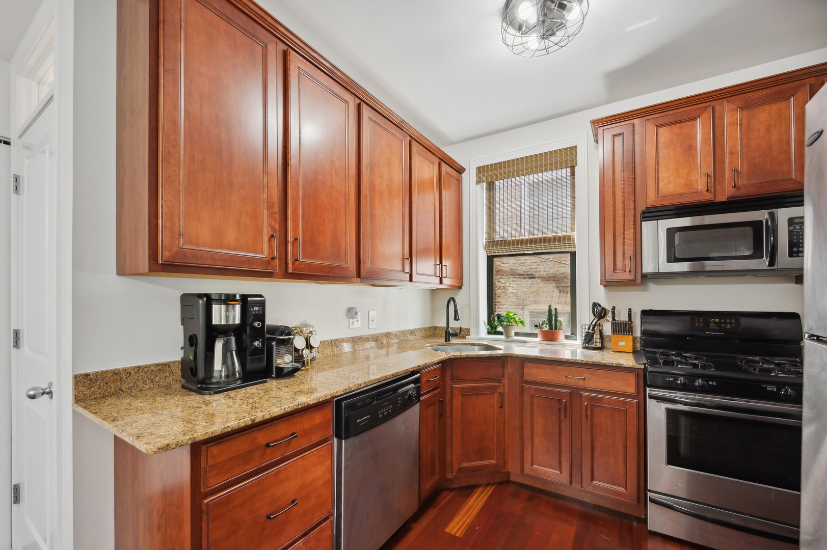 1610 West Byron Street, Unit 2 Chicago, IL 60613 - Photo 12 of 21 a kitchen with a sink stove top oven and cabinets