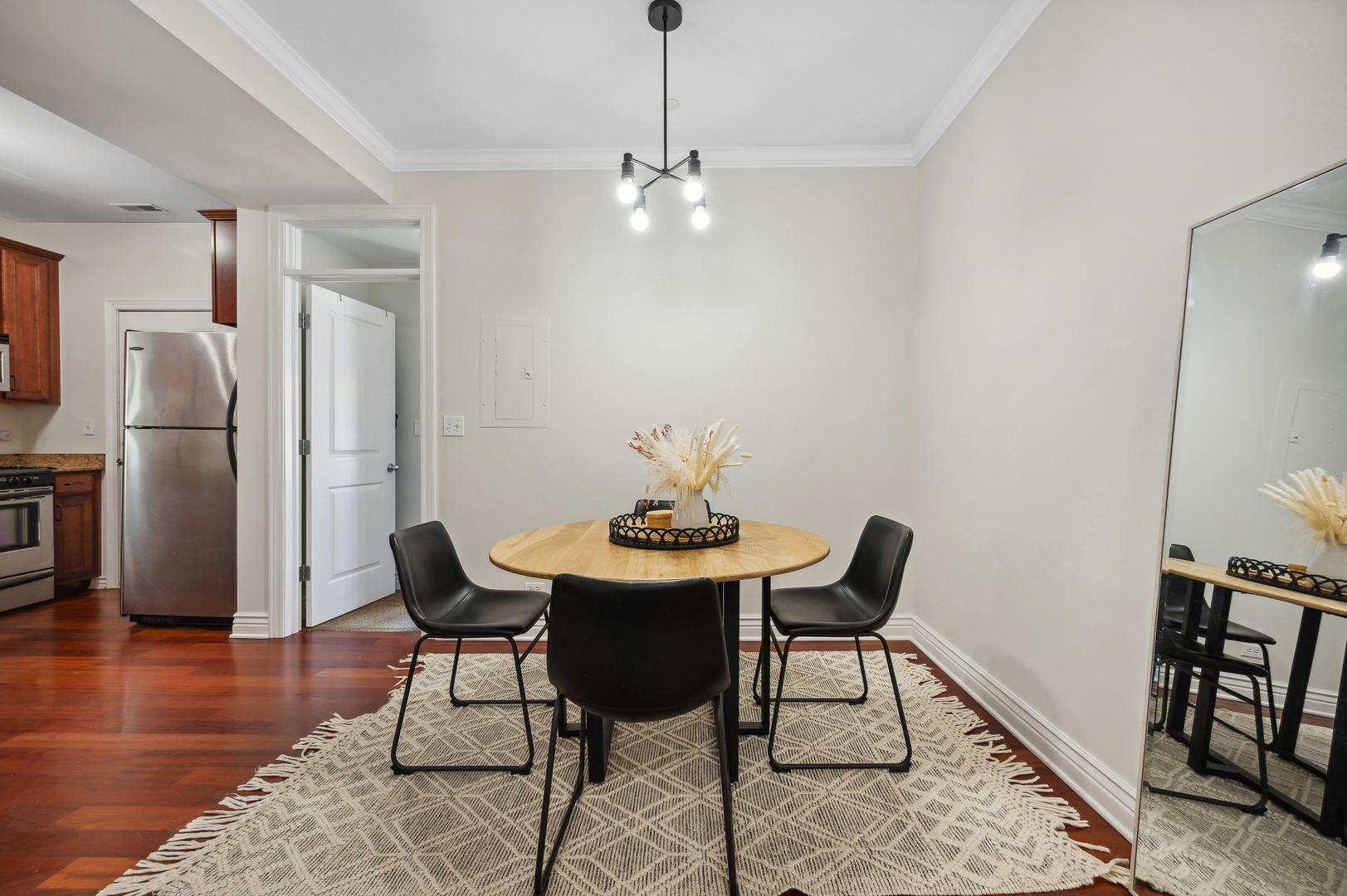 1610 West Byron Street, Unit 2 Chicago, IL 60613 - Photo 14 of 21 a view of a dining room with furniture and a chandelier