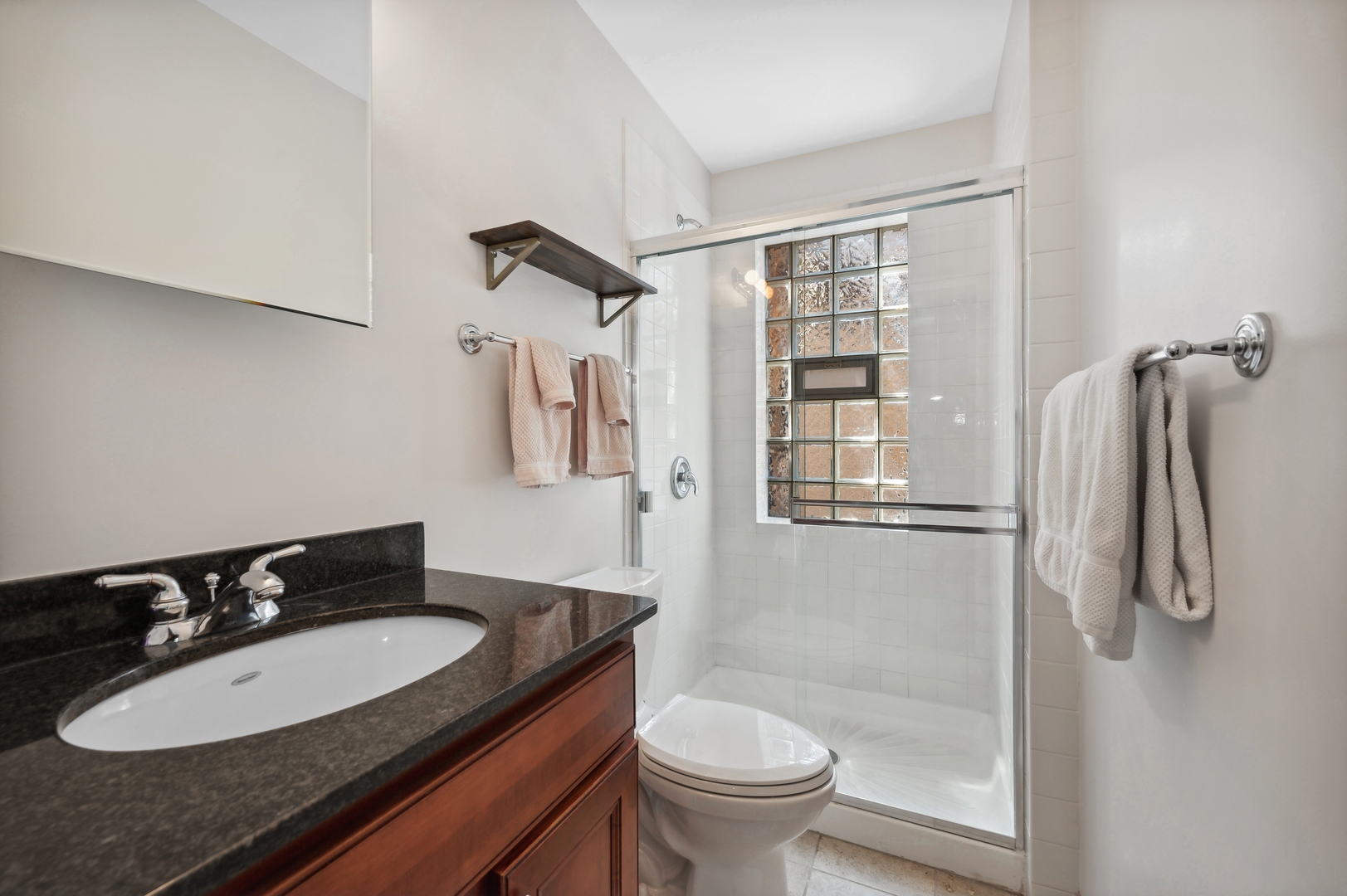 1610 West Byron Street, Unit 2 Chicago, IL 60613 - Photo 19 of 21 a bathroom with a granite countertop sink a toilet and shower