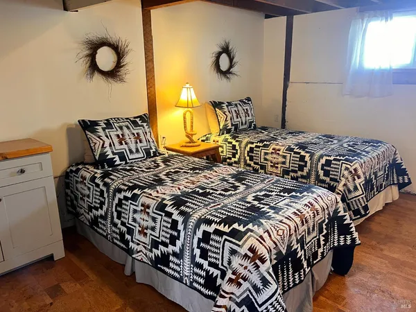 a bed sitting in a bedroom next to a window