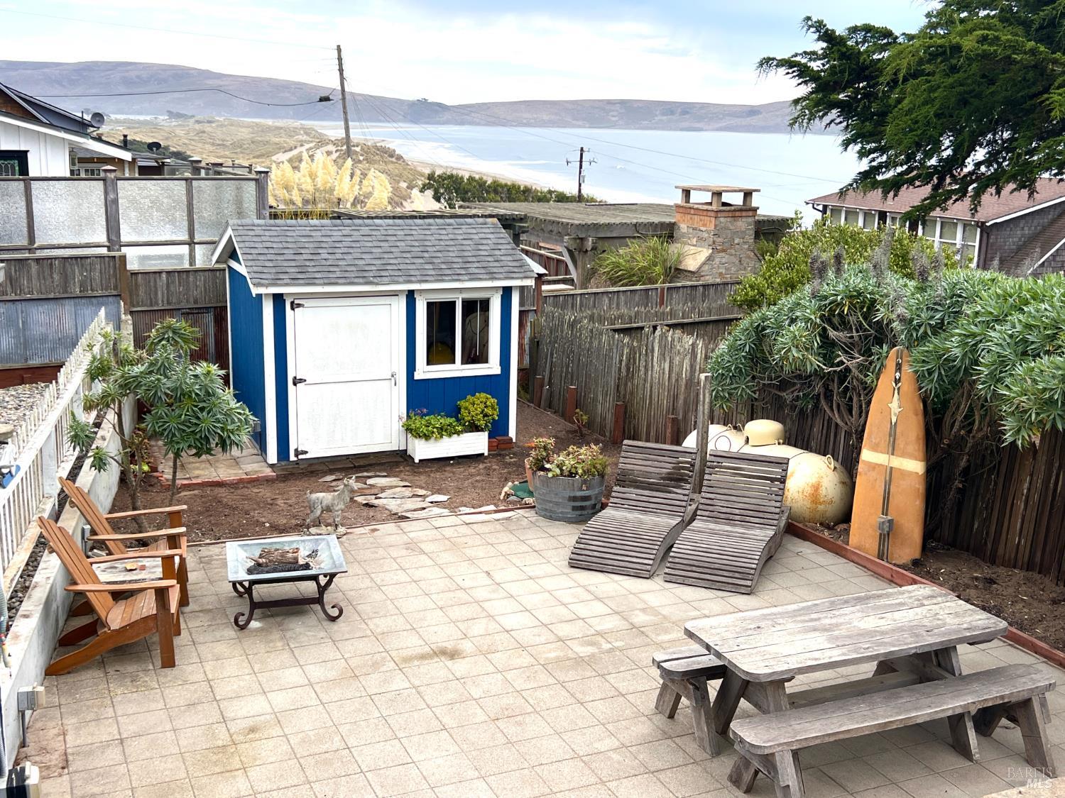75 Ocean View Avenue Dillon Beach, CA 94929 - Photo 13 of 23 a view of a patio with a table and chairs and potted plants