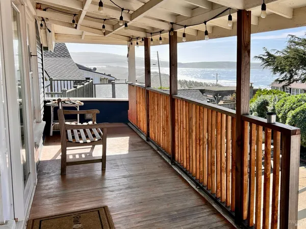 a balcony with wooden floor outdoor seating