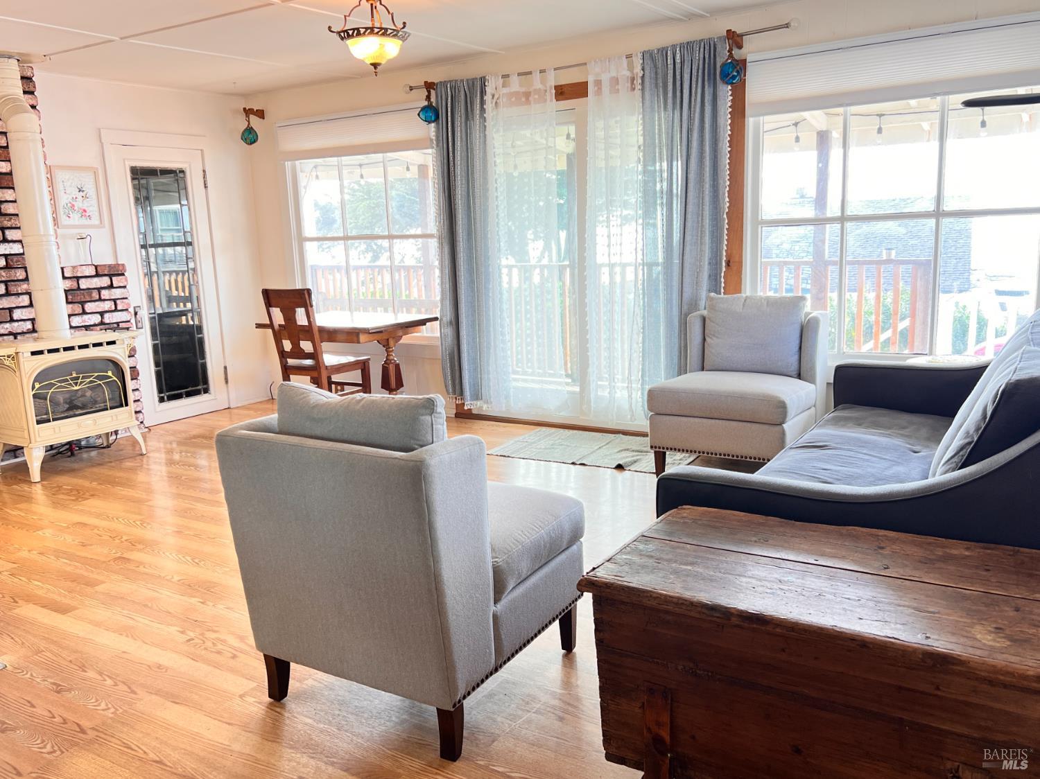 75 Ocean View Avenue Dillon Beach, CA 94929 - Photo 3 of 23 a living room with furniture and a large window