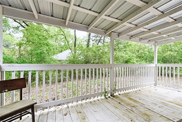 a view of balcony with wooden floor