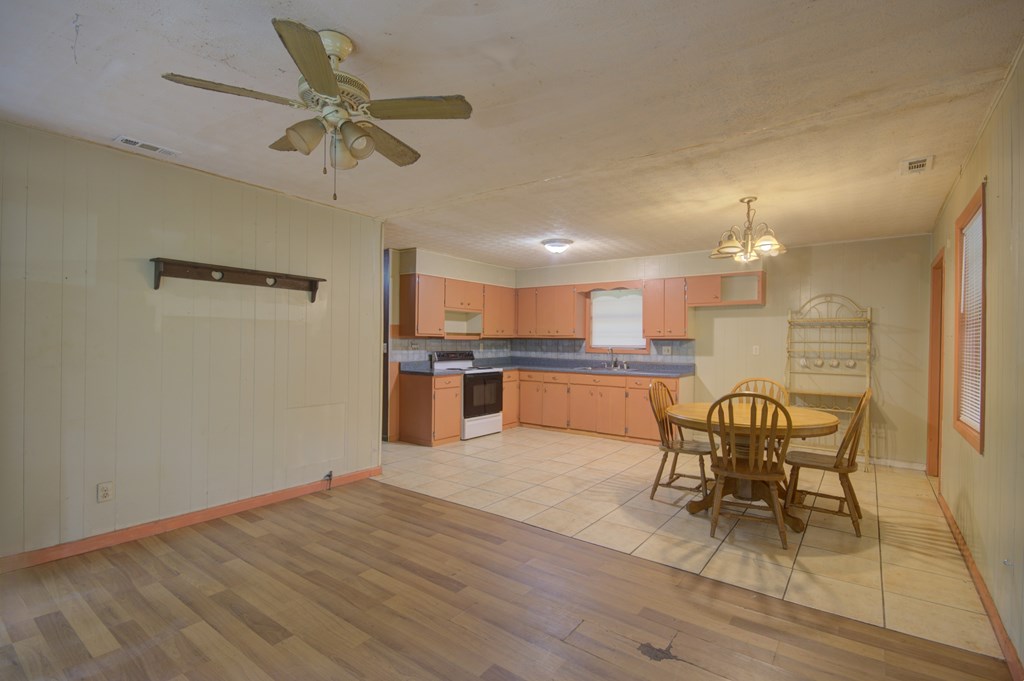 92 No-Where Road Blairsville, GA 30512 - Photo 2 of 36 a kitchen with stainless steel appliances kitchen island granite countertop a table chairs and a refrigerator