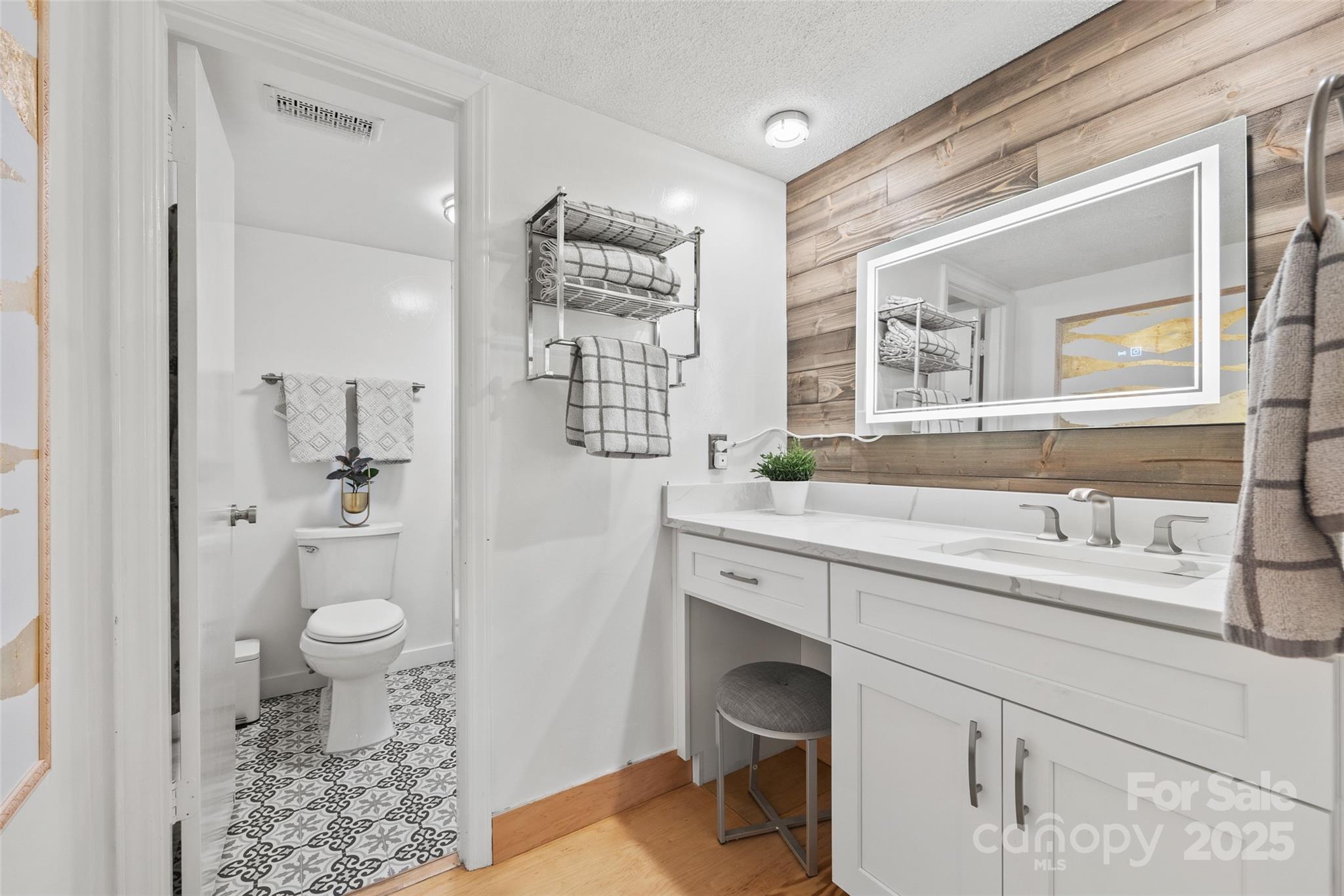 4609 Rounding Run Road Charlotte, NC 28277 - Photo 32 of 48 a spacious bathroom with a sink a toilet a large mirror and shower