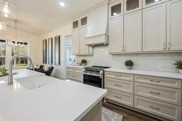a kitchen with granite countertop white cabinets and white appliances