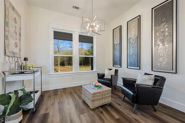 a living room with furniture and a chandelier