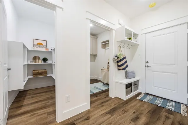 a view of a livingroom with wooden floor and white cabinet