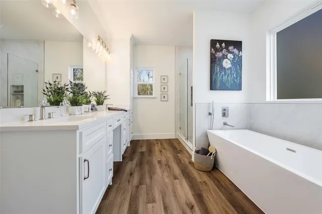 a bathroom with a bathtub a sink and a mirror