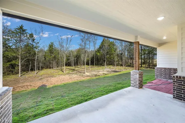 a view of a backyard with porch and garden