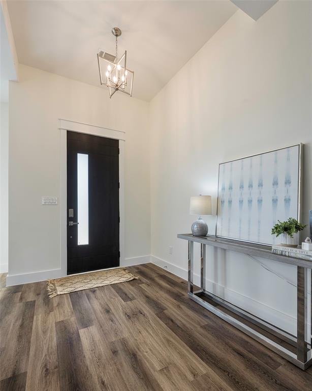 424 Private Road 5440 Point, TX 75472 - Photo 5 of 32 a view of a livingroom with wooden floor and a chandelier