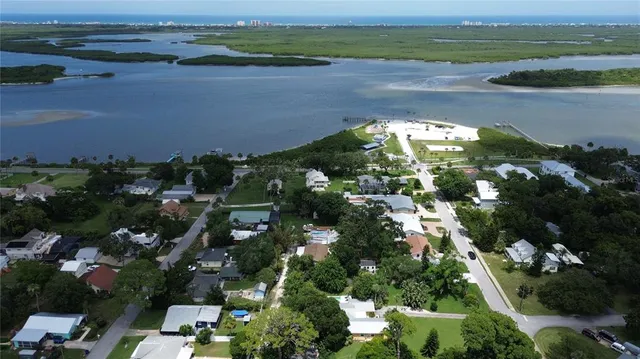 an aerial view of a houses with ocean view