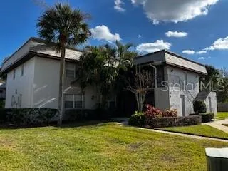 a view of house with yard and tree in front of it
