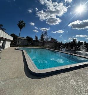 92 Windtree Lane, Unit 201 Winter Garden, FL 34787 - Photo 15 of 17 a view of a swimming pool with a yard