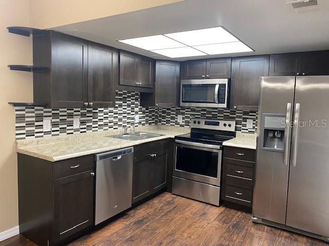 92 Windtree Lane, Unit 201 Winter Garden, FL 34787 - Photo 6 of 17 a kitchen with stainless steel appliances kitchen island granite countertop a stove a sink and a refrigerator
