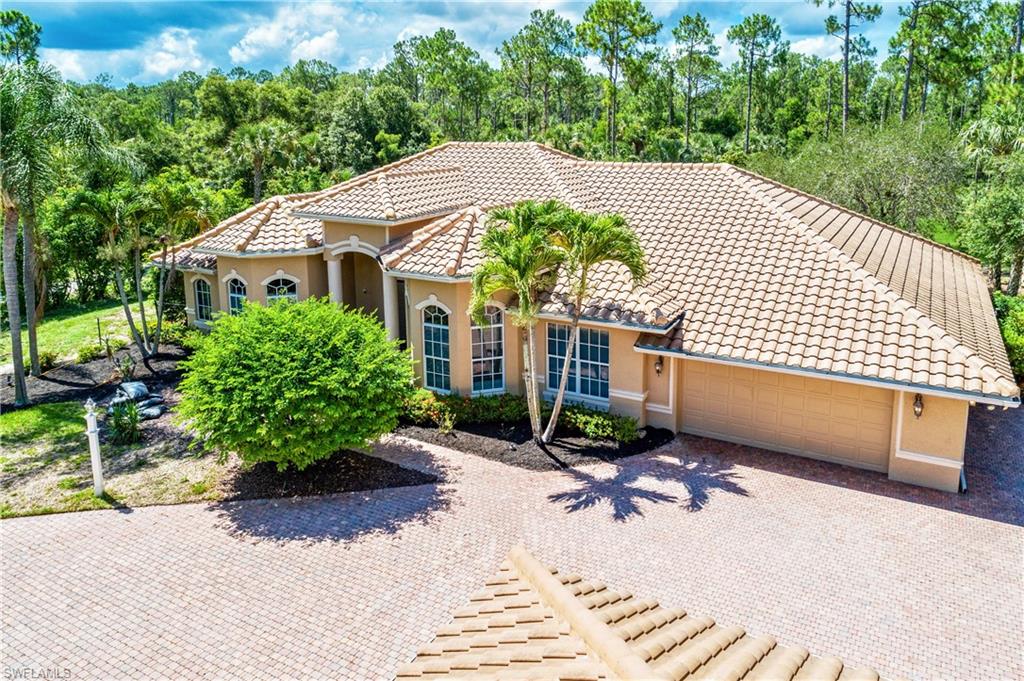 a view of a house with a yard and potted plants