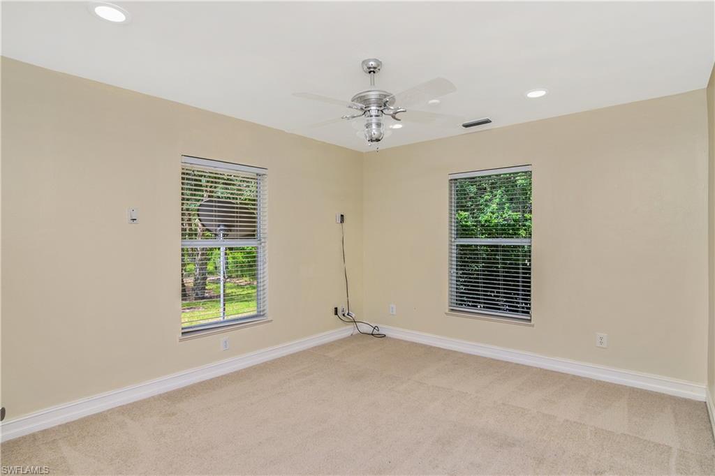4430 Pine Ridge Road Naples, FL 34119 - Photo 23 of 35 an empty room with windows and closet