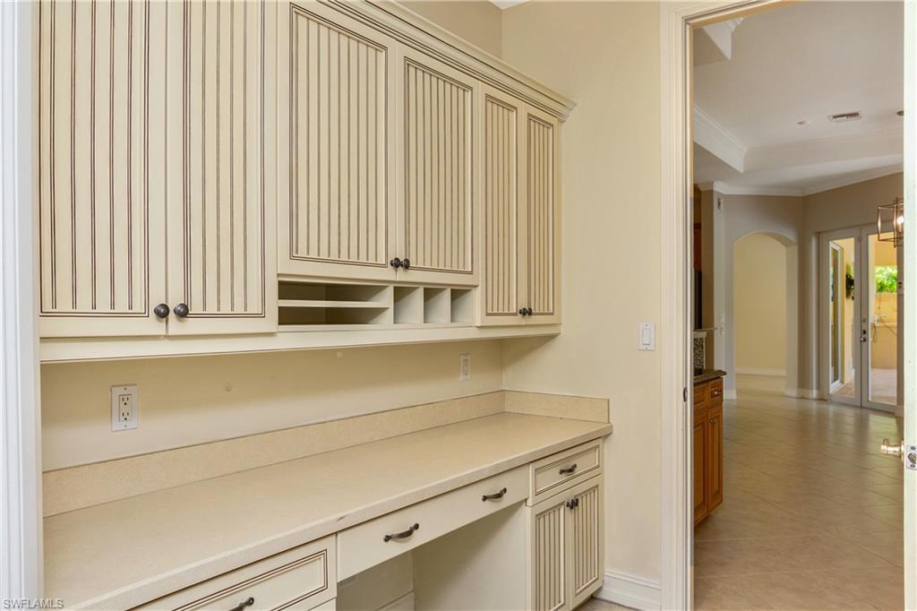 4430 Pine Ridge Road Naples, FL 34119 - Photo 27 of 35 a kitchen with a sink and cabinets