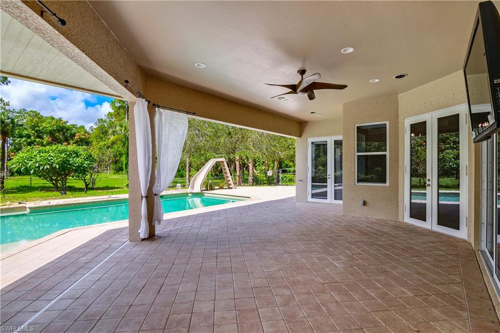 4430 Pine Ridge Road Naples, FL 34119 - Photo 29 of 35 a view of a porch with furniture and garden
