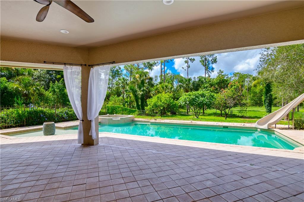 4430 Pine Ridge Road Naples, FL 34119 - Photo 30 of 35 a view of a yard with a slide