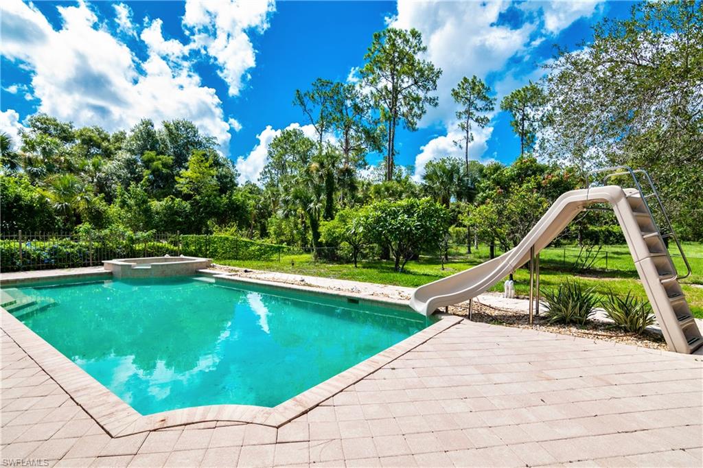 4430 Pine Ridge Road Naples, FL 34119 - Photo 31 of 35 a view of swimming pool with lounge chair