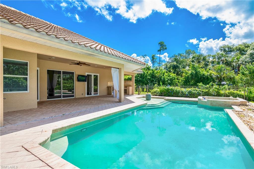 4430 Pine Ridge Road Naples, FL 34119 - Photo 32 of 35 a view of a house with backyard porch and sitting area