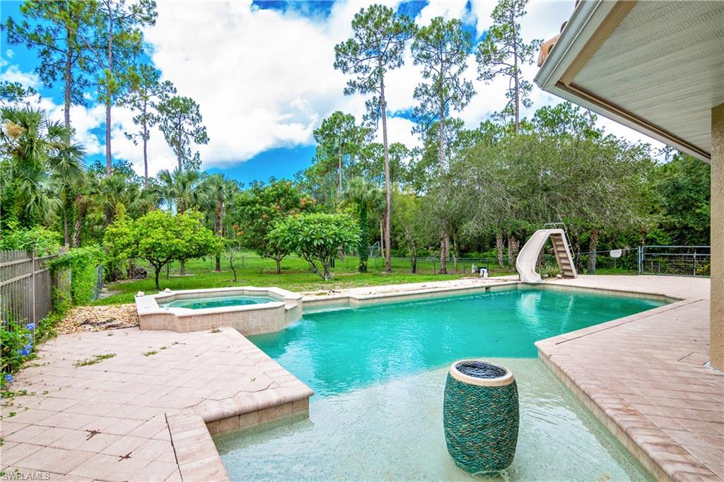 4430 Pine Ridge Road Naples, FL 34119 - Photo 33 of 35 a view of a swimming pool with a patio