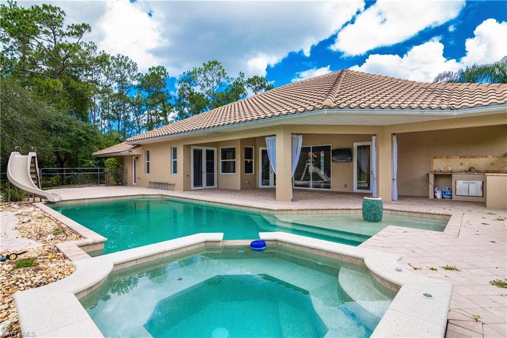 4430 Pine Ridge Road Naples, FL 34119 - Photo 34 of 35 a view of a house with a swimming pool